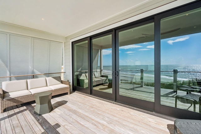 exterior space featuring an outdoor living space and a water view