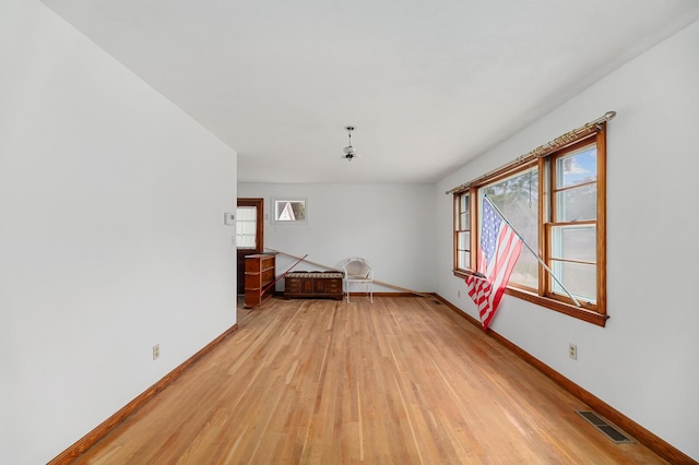 2708 Mawood Ave, North Charleston, SC 29406 - unfurnished living room with light wood-type flooring and baseboards