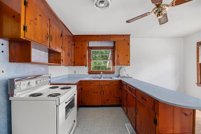 2708 Mawood Ave, North Charleston, SC 29406 - kitchen featuring white electric range, a sink, a peninsula, ceiling fan, and light flooring