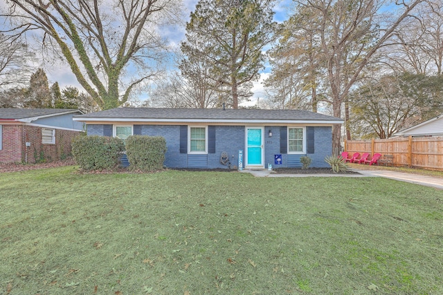 single story home featuring brick siding, fence, and a front lawn