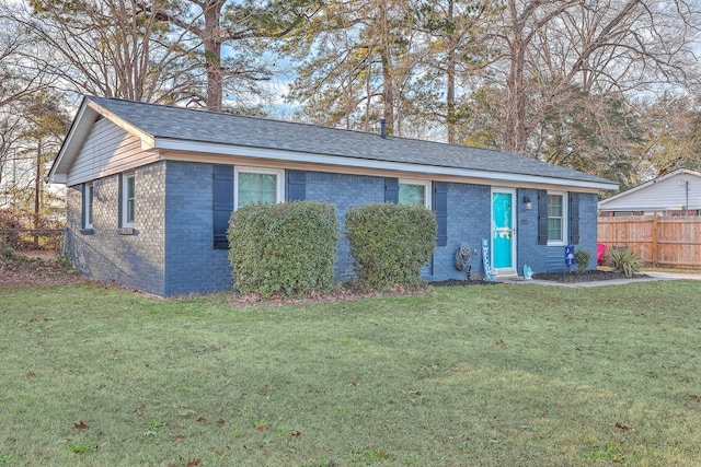 ranch-style house with a front yard, brick siding, fence, and roof with shingles