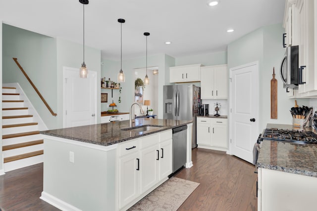 kitchen with sink, stainless steel appliances, dark wood-type flooring, an island with sink, and white cabinets