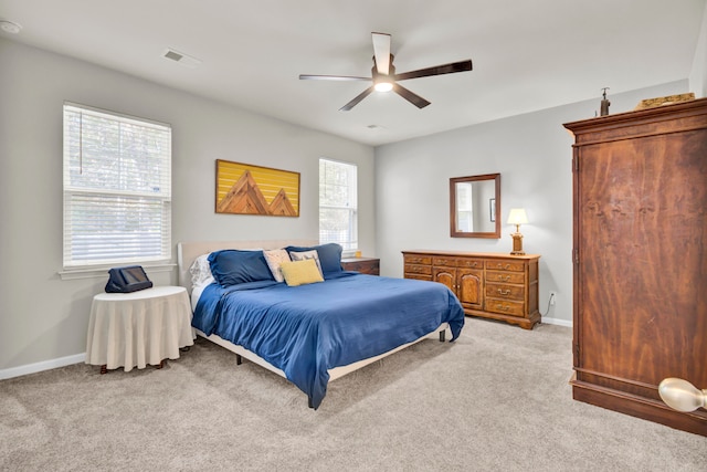 bedroom featuring ceiling fan and light carpet