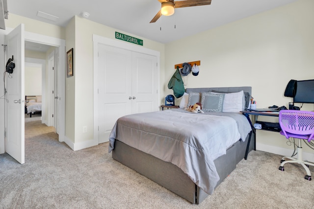 carpeted bedroom featuring a closet and ceiling fan