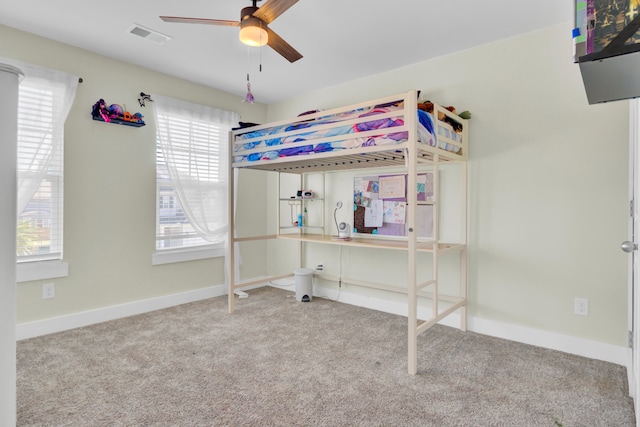 unfurnished bedroom featuring carpet floors and ceiling fan