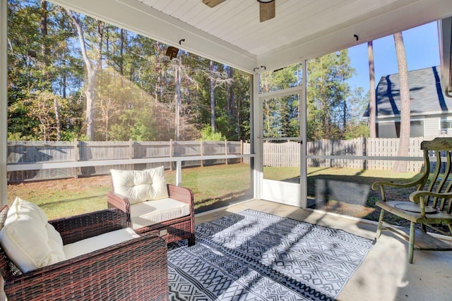 sunroom / solarium featuring ceiling fan