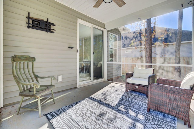 sunroom / solarium featuring ceiling fan, lofted ceiling, and a wealth of natural light