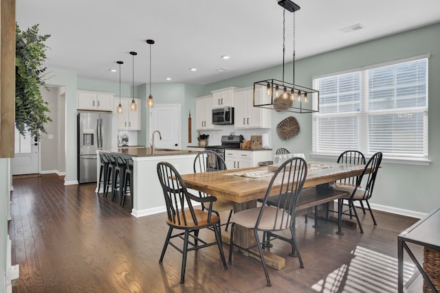 dining area featuring sink and dark hardwood / wood-style floors