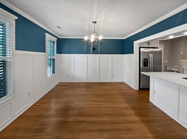 932 Portabella Ln, Charleston, SC 29412 - unfurnished dining area featuring a decorative wall, crown molding, a chandelier, a wainscoted wall, and dark wood-style flooring