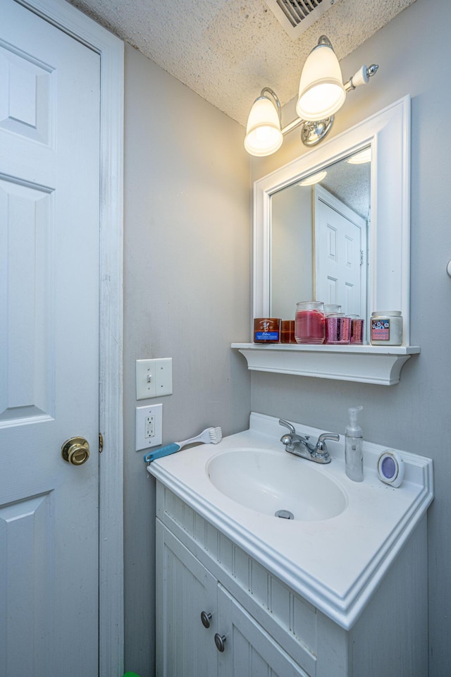 bathroom with vanity and a textured ceiling