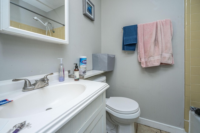 bathroom with tile patterned flooring, vanity, and toilet