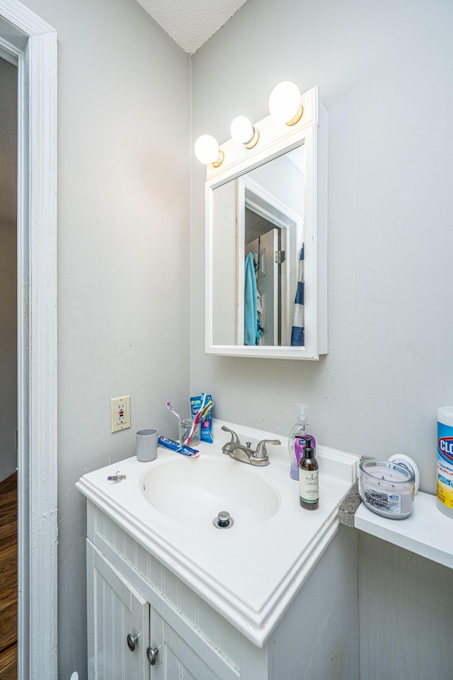 bathroom featuring vanity and a textured ceiling