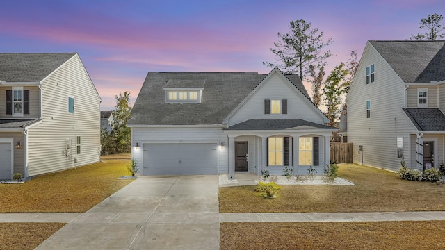 view of front of house with a garage and a yard