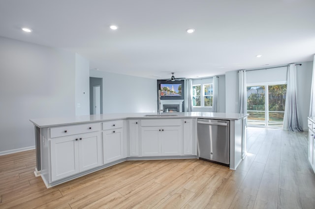 kitchen featuring dishwasher, white cabinetry, an island with sink, and light hardwood / wood-style flooring