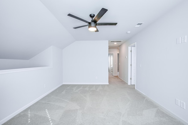 additional living space featuring light carpet, ceiling fan, and vaulted ceiling