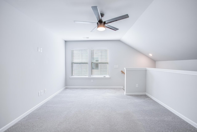 bonus room featuring light colored carpet, vaulted ceiling, and ceiling fan