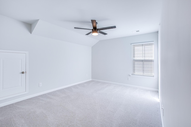 carpeted empty room with ceiling fan and lofted ceiling