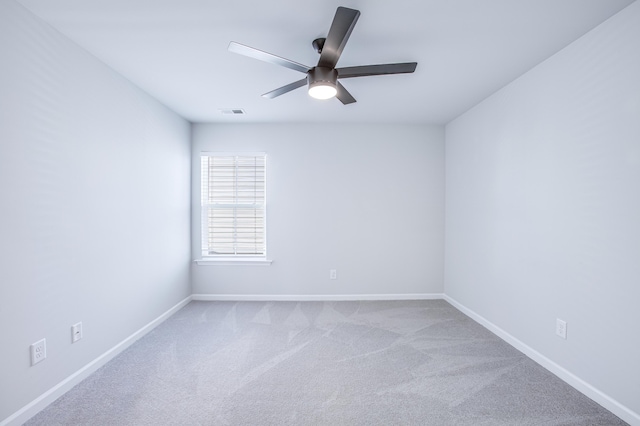 carpeted spare room featuring ceiling fan