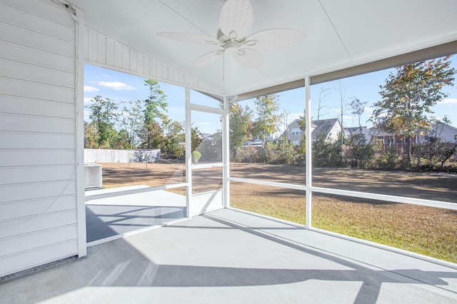 unfurnished sunroom with ceiling fan