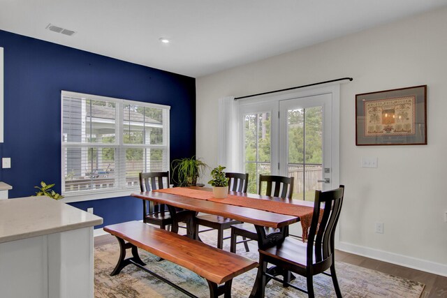 kitchen with high end stove, light wood-type flooring, and white cabinetry