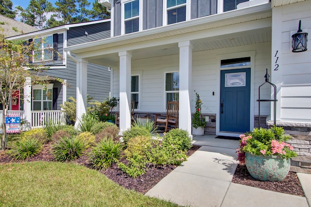 view of exterior entry with a porch