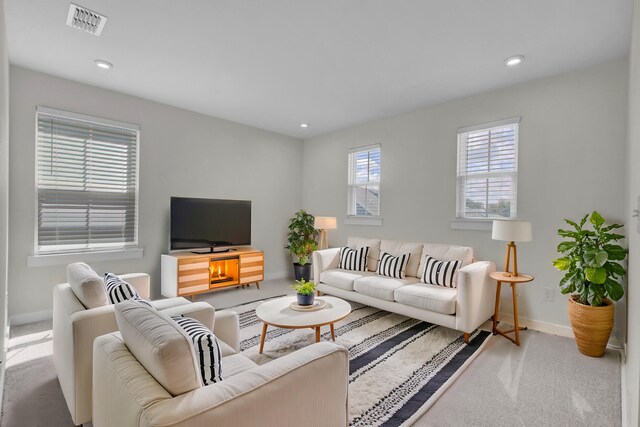 living room featuring ceiling fan, dark hardwood / wood-style floors, a fireplace, and sink