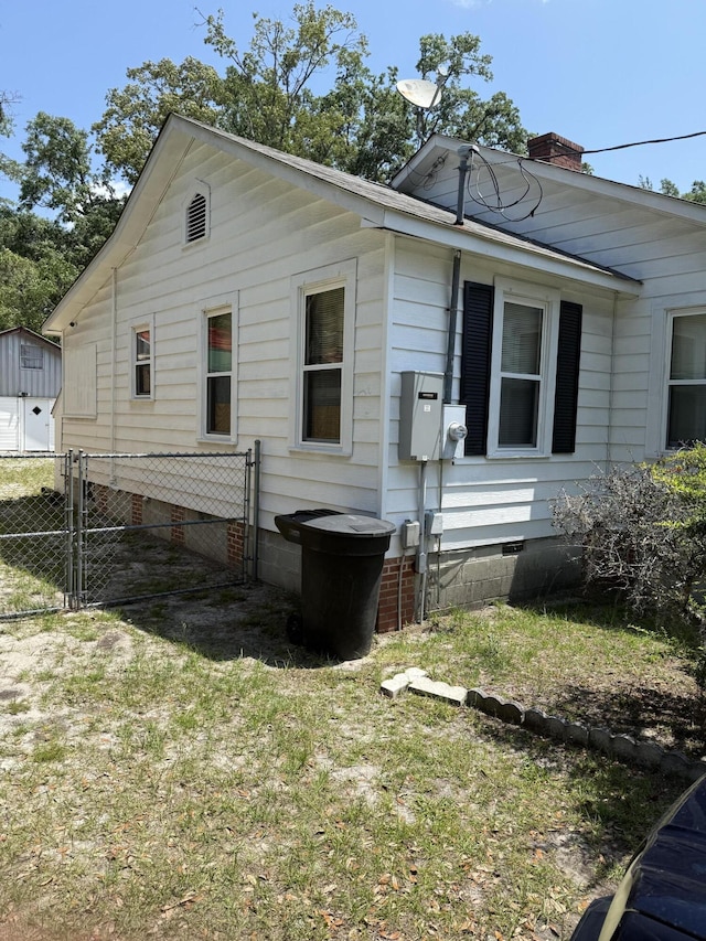 505 Blacks St, Walterboro, SC 29488 - view of property exterior with crawl space, a chimney, and a gate