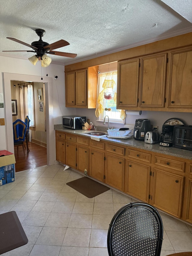 505 Blacks St, Walterboro, SC 29488 - kitchen featuring a sink, stainless steel microwave, brown cabinetry, a textured ceiling, and ceiling fan