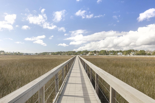 view of dock with a rural view