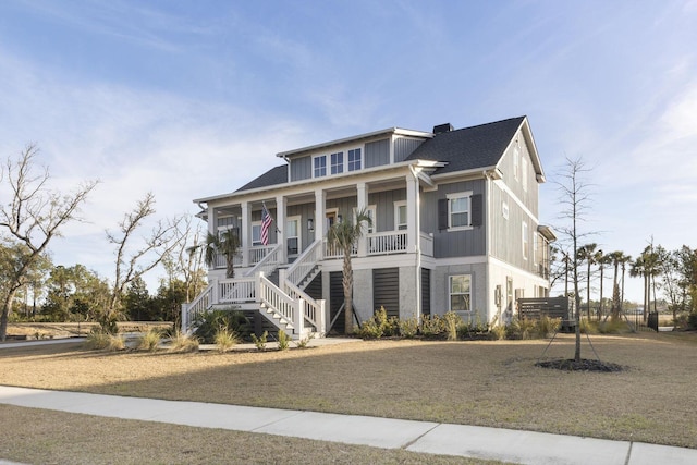 raised beach house with covered porch and stairs