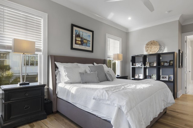 bedroom featuring crown molding and wood finished floors