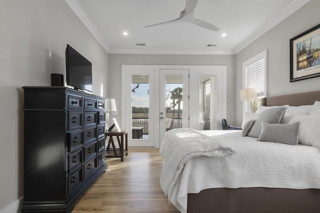 bedroom with light wood-type flooring, access to outside, multiple windows, and crown molding