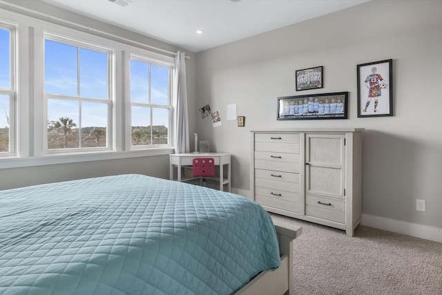 bedroom featuring light carpet and baseboards