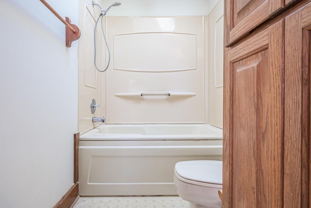 bathroom featuring washtub / shower combination and toilet