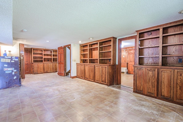 unfurnished living room with recessed lighting and a textured ceiling