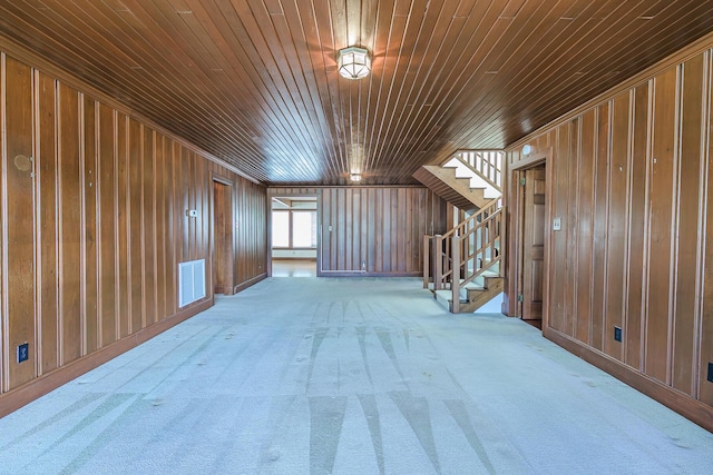 bonus room featuring wooden walls, visible vents, wooden ceiling, and stairway