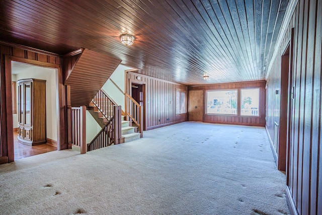 bonus room with carpet floors, wooden walls, stairway, and wooden ceiling