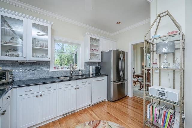 5847 Back Bay Dr, Isle Of Palms, SC 29451 - kitchen featuring white dishwasher, freestanding refrigerator, a sink, light wood finished floors, and backsplash
