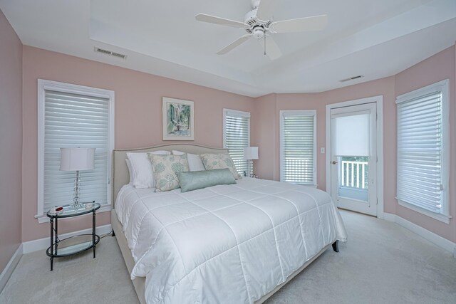 5847 Back Bay Dr, Isle Of Palms, SC 29451 - bedroom with light carpet, a raised ceiling, access to exterior, and baseboards