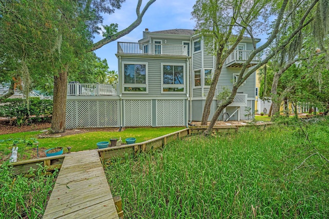 5847 Back Bay Dr, Isle Of Palms, SC 29451 - back of house featuring a balcony, a lawn, a chimney, and a wooden deck