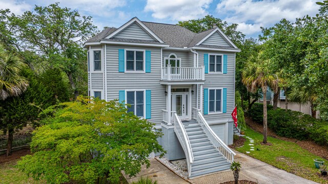 5847 Back Bay Dr, Isle Of Palms, SC 29451 - coastal inspired home featuring a garage, a balcony, a shingled roof, driveway, and stairway