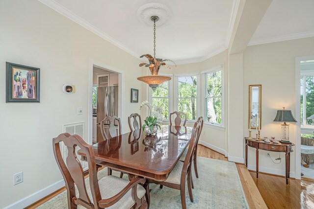 5847 Back Bay Dr, Isle Of Palms, SC 29451 - dining space featuring light wood finished floors, crown molding, and baseboards