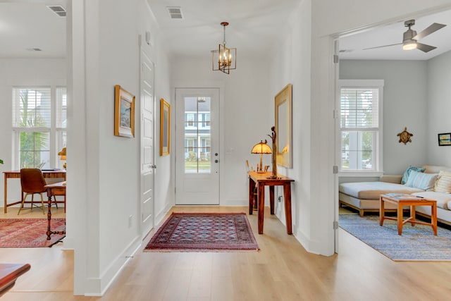 entrance foyer with light wood-type flooring and a healthy amount of sunlight