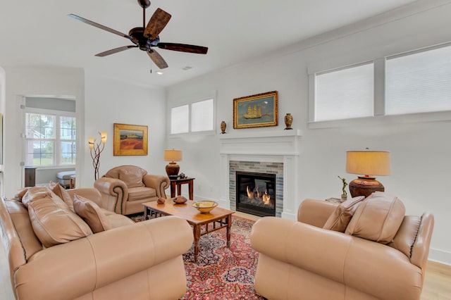 living room with ceiling fan, light wood-type flooring, and crown molding