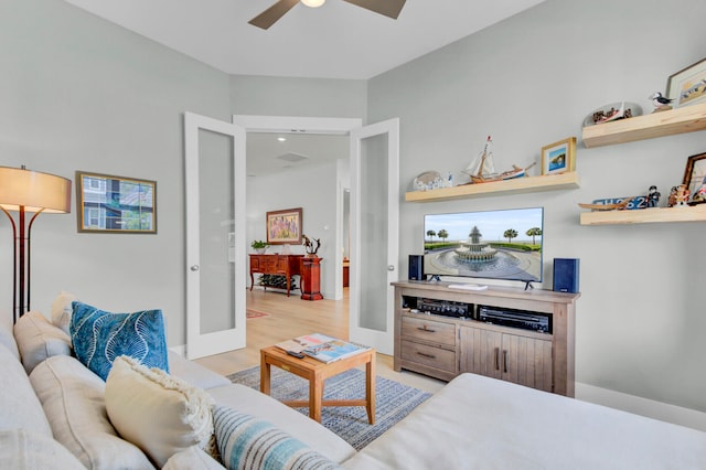 living room with french doors, light hardwood / wood-style flooring, and ceiling fan