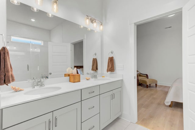 bathroom featuring hardwood / wood-style floors, vanity, and walk in shower