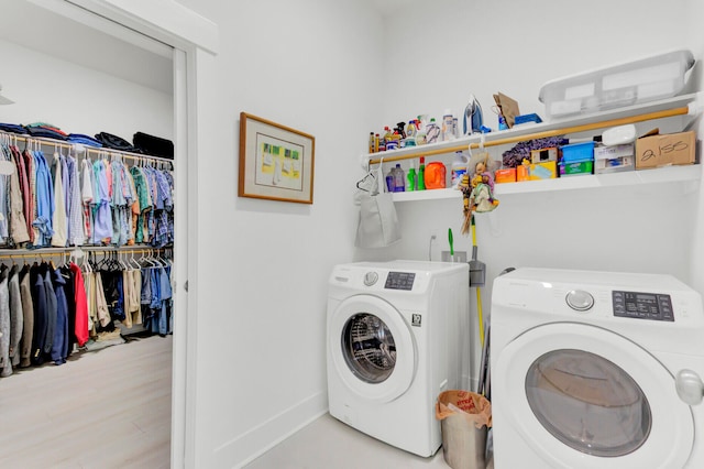 washroom featuring washing machine and dryer and light hardwood / wood-style floors