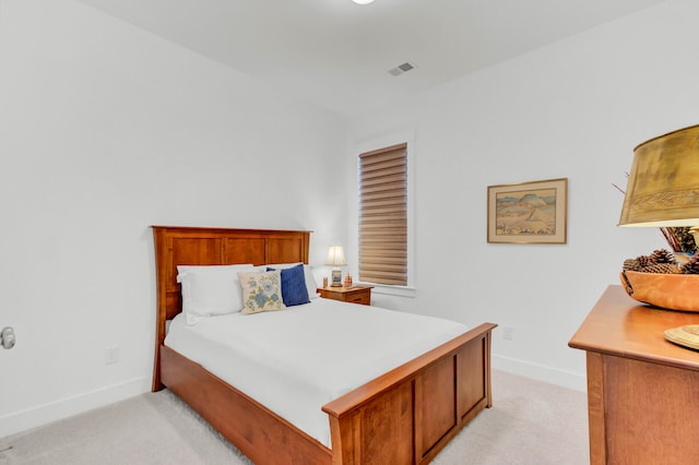 bedroom with light colored carpet