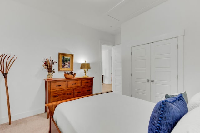 bedroom with light carpet and a closet