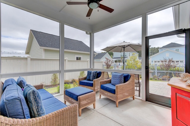 sunroom / solarium with plenty of natural light and ceiling fan